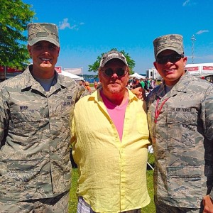 Mario Batali poses with two members of the National Guard while taping a segment for "The Chew" at the National Cherry Festival in Traverse City.